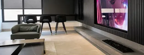 Murano dark media lounge with backlit display wall
